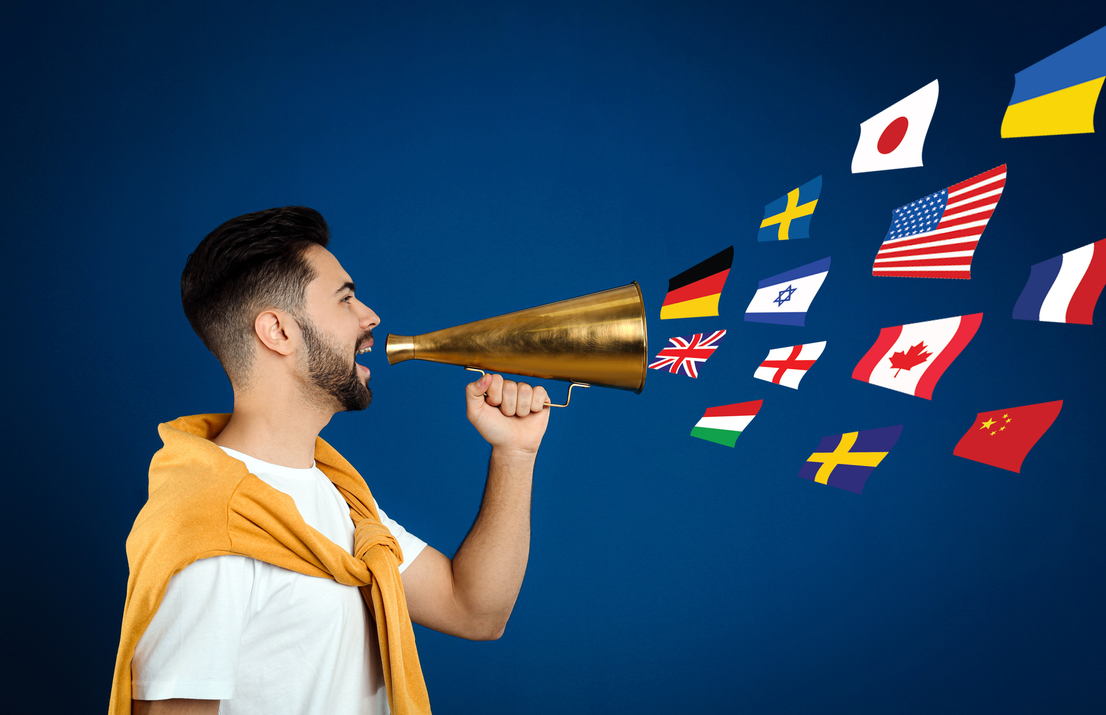 Young Man with Megaphone on Blue Background